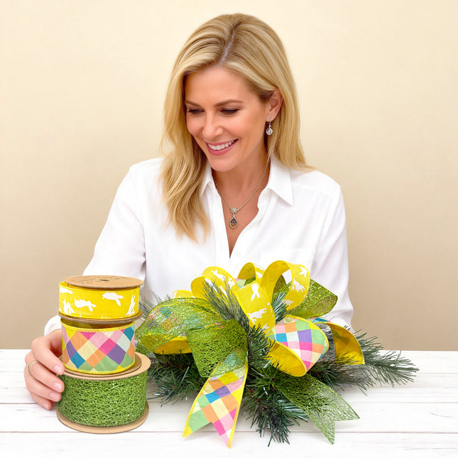 Woman crafting an Easter bow with yellow bunny, plaid, and green mesh ribbons.