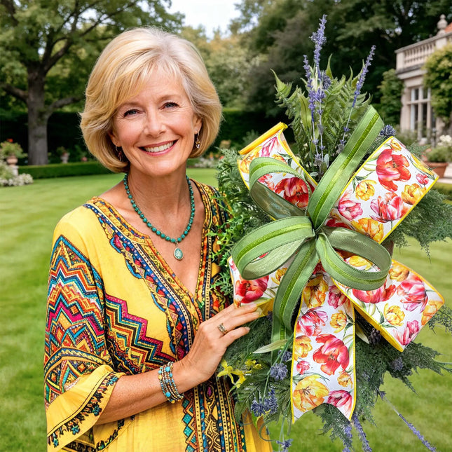 Cheerful spring floral arrangement with tulip print and green velvet wired ribbon bow, styled in a sunny garden setting.
