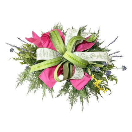 Bright spring bow arrangement with hot pink dupioni, green herb print, and green velvet stripe wired ribbons, accented with greenery and lavender.