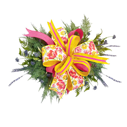 Bright spring bow arrangement with tulip print, yellow-pink velvet stripe, and bright pink linen ribbons, accented with greenery and lavender.
