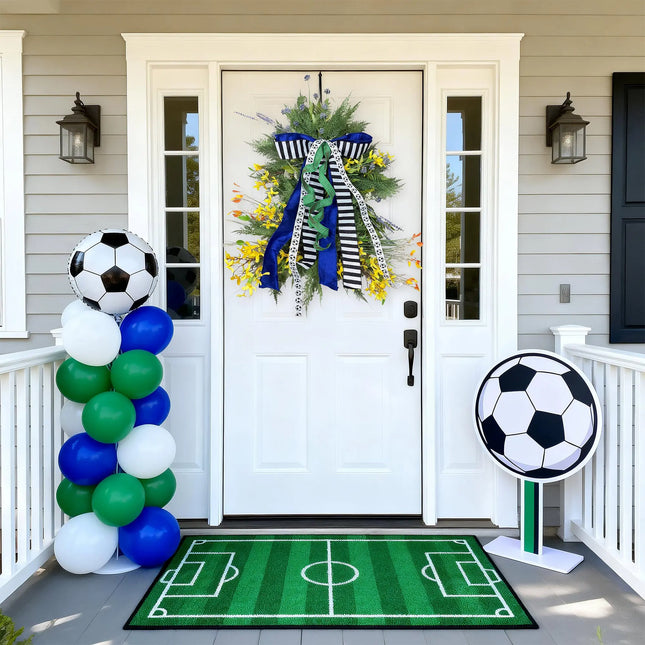 Soccer-themed front porch decor featuring a wreath, soccer field doormat, and balloon accents for game day.