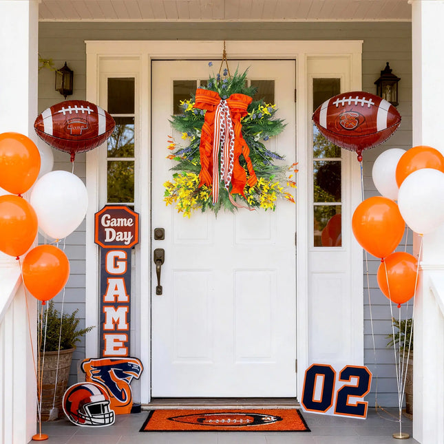 Orange and white football-themed front porch decor with a wreath, balloons, and game day accents.