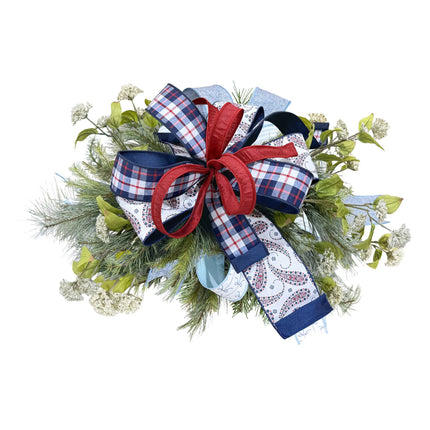 Patriotic wired ribbon bow featuring blue paisley, red-white-blue plaid, and red dupioni ribbons, styled with greenery