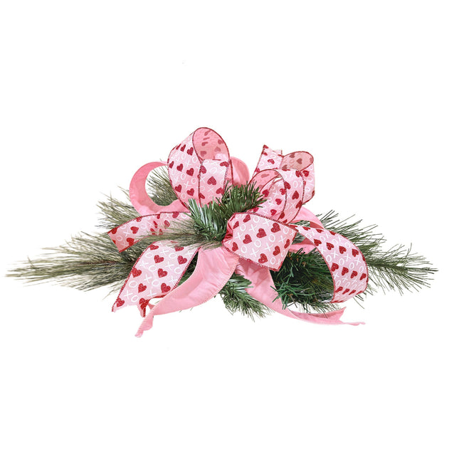 Valentine ribbon decor: pink ribbon (red glitter hearts/XO) arranged on pine foliage