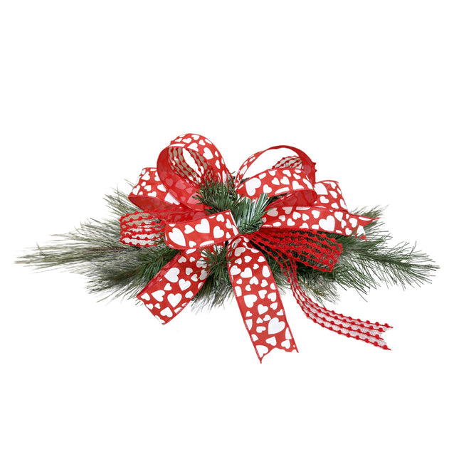 Valentine’s Day ribbon decor: red-white heart ribbons, textured trim, on pine foliage