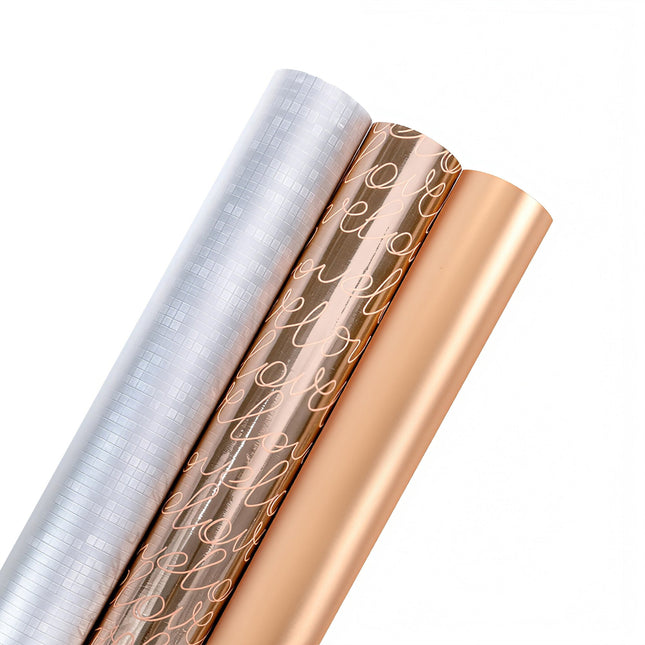 Metallic wrapping paper rolls: silver grid, rose gold "love" script, solid rose gold; gift wrapping.