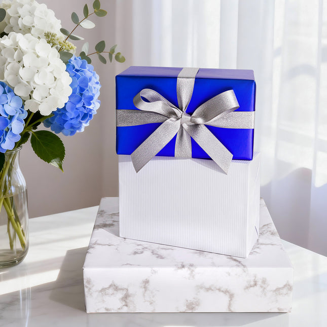 Shiny royal blue gift wrap with silver glitter ribbon bow, for upscale gifts.