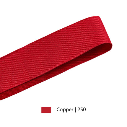 Red textured grosgrain ribbon spool, perfect for DIY crafts, holiday decor, and gift embellishments.
