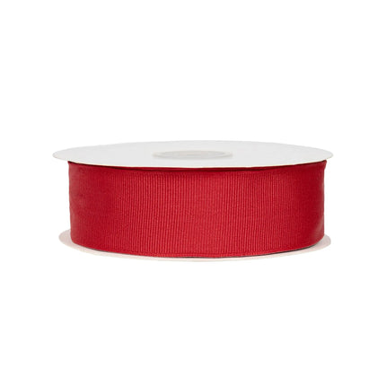 A roll of red textured grosgrain ribbon, great for embellishing gift baskets