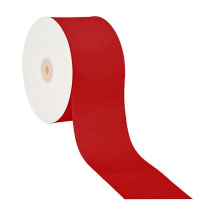Red textured grosgrain ribbon on white spool, partially unrolled