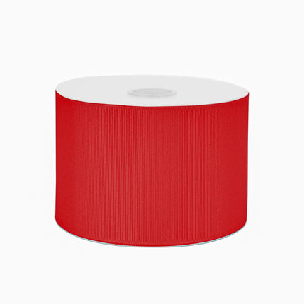 Full roll of vibrant red textured grosgrain ribbon on white spool