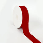 Spool of scarlet grosgrain ribbon, unrolled to display its textured weave.