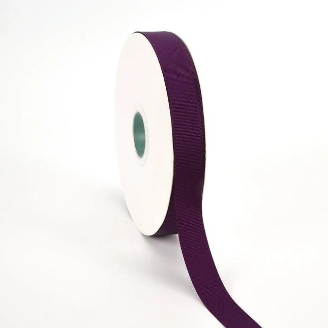 Spool of plum grosgrain ribbon, unrolled to display its textured weave.