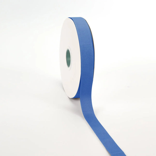 Spool of royal grosgrain ribbon, unrolled to display its textured weave.