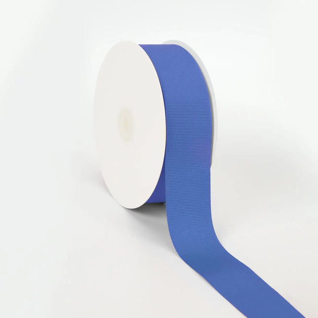 Spool of royal grosgrain ribbon, unrolled to display its textured weave.