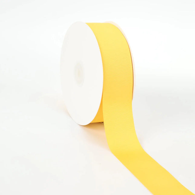 Spool of maize grosgrain ribbon, unrolled to display its textured weave.