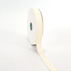 Spool of ivory grosgrain ribbon, unrolled to display its textured weave.