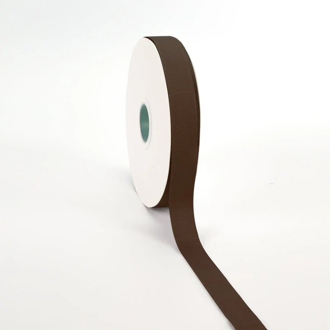 Spool of brown grosgrain ribbon, unrolled to display its textured weave.