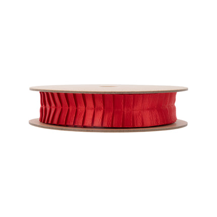 Full roll of vibrant red structured pleated ribbon on spool