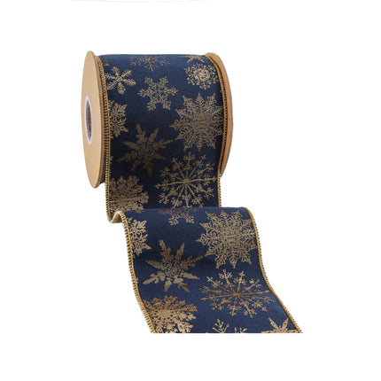 Roll of 4" wired jacquard ribbon, navy blue with golden snowflakes, showcasing its rich texture and design.