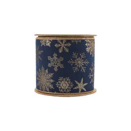 Compact roll of 4" navy blue wired jacquard ribbon with elaborate gold snowflake patterns.