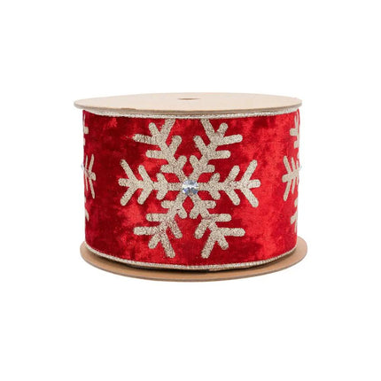A roll of 4" wired velvet Christmas ribbon, red with glittering gold snowflakes and jewel details, perfect for adding a glamorous touch to holiday decorations.