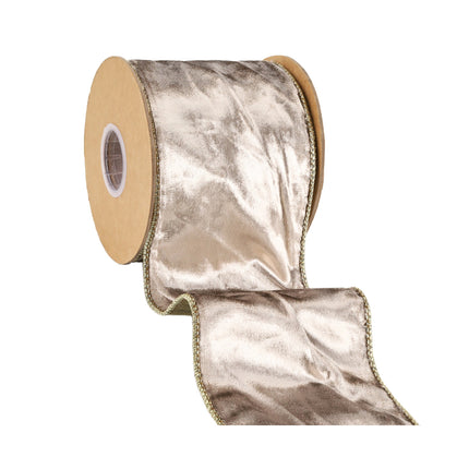 A roll of metallic gold velvet ribbon with a reversible design and gold trim, great for creating upscale holiday accents and decorative crafts.