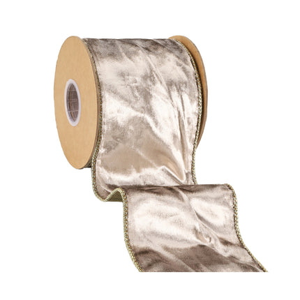 Partially unfurled pale gold velvet ribbon roll, crinkled shimmer, luxe gold wired edge.