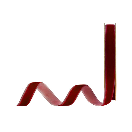 A roll of bordeaux red velvet ribbon, great for tying gourmet wine gift bags and decorating formal dinner table napkins.