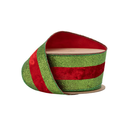 Green glitter & red velvet striped ribbon on spool, vivid texture, festive craft.