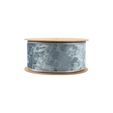 A spool of blue velvet ribbon with wired edges, perfect for gift wrapping, and handmade crafts.