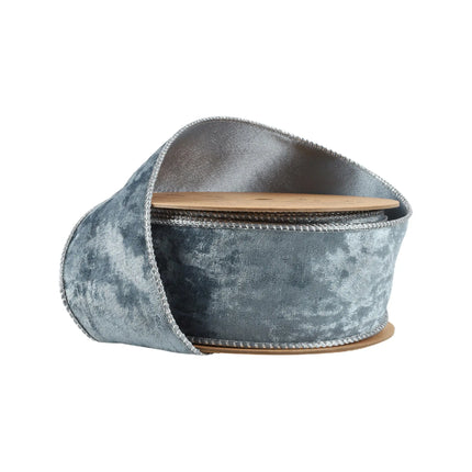 A roll of elegant blue velvet ribbon with wired edges, ideal for holiday decorating.