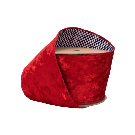 A spool of wired velvet ribbon in red, featuring a black-and-white check backing, ideal for adding a bold touch to crafts and decorations.