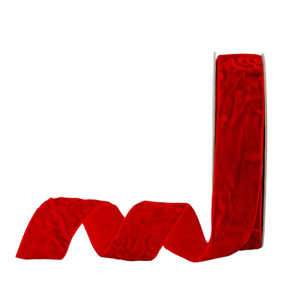 A spool of red velvet ribbon, ideal for Christmas decor, luxurious gift wrapping, and elegant crafting projects.