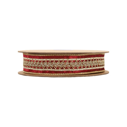 A  red velvet ribbon with intricate gold embroidered designs, ideal for elevating luxurious holiday decorations and crafting with a refined, opulent feel.