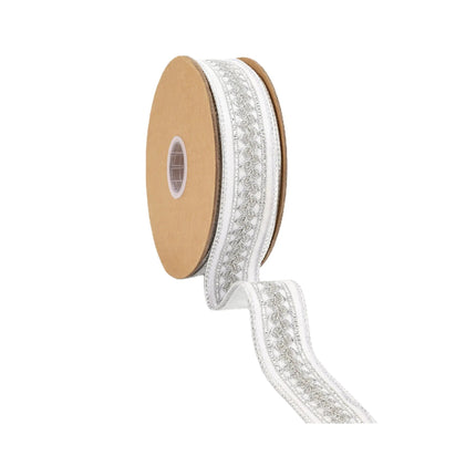 A reel of ribbon is adorned with silver embroidered patterns on a white background, combined with metallic elements.