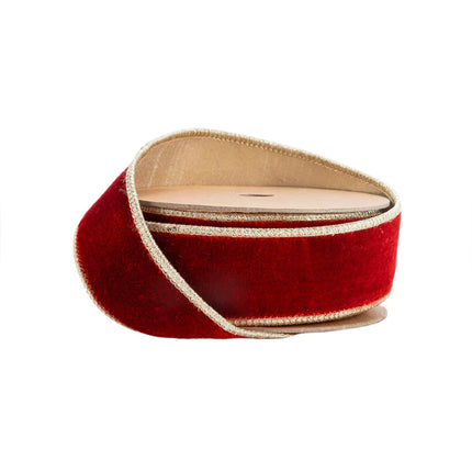 A spool of rich red velvet ribbon with gold metallic edges and backing, ideal for luxurious Christmas decor.