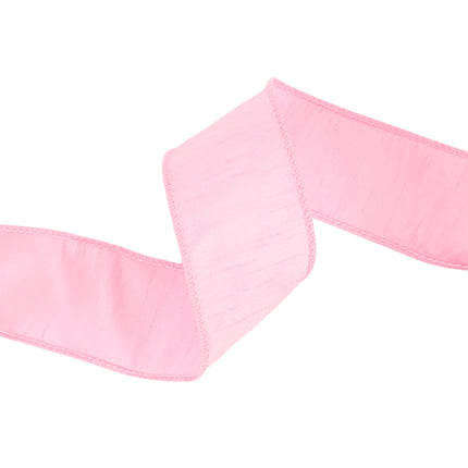 Pink wired dupioni ribbon folded into soft waves, textured woven fabric.