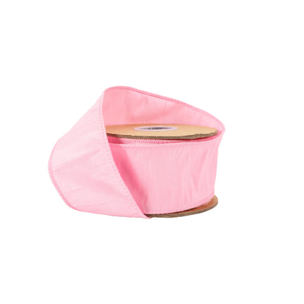Pink wired dupioni ribbon on spool, textured fabric with neat stitched edges.