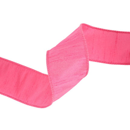 Hot Pink wired dupioni ribbon folded into waves, woven textured fabric.