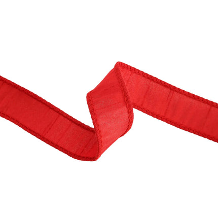 A strip of red ribbon, with stitched edges and a textured surface, presents a vibrant option for festive decor.