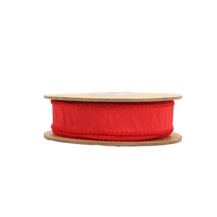 This red ribbon featuring stitched edges and a textured fabric design, great for holiday projects.
