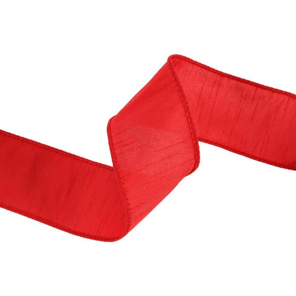 This red ribbon with a classic, solid color and a soft, woven texture, partially unfurled to highlight its elegant appearance.