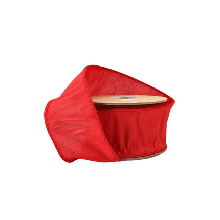 A spool of vibrant red ribbon with a soft, slightly textured fabric, ideal for festive or decorative uses.