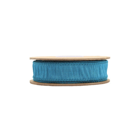 Teal woven fabric ribbon on a spool, featuring fine stitching, ideal for gift embellishing, and DIY crafts.