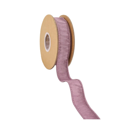 A reel of purple ribbon has a distinctive woven texture with a hint of understated luster, suitable for crafting stylish.