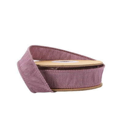 A spool of purple ribbon features a textured, slightly slubbed surface with neat edge stitching, ideal for decorative projects.