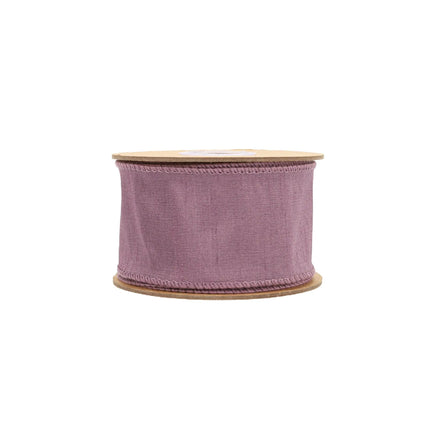 A roll of purple ribbon exhibits a rich, textured finish with a subtle, wrinkled effect and a muted mauve color, great for handmade crafts.