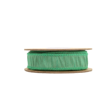The green ribbon having stitched edges and a textured fabric appearance, great for DIY crafts .