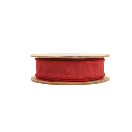 A spool of red decorative ribbon with a woven ,stitched edges, perfect for decorative uses.